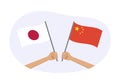 Japan and China flags. Chinese and Japanese national symbols. Hand holding waving flag. Vector Royalty Free Stock Photo